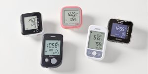 Five diabetes monitors arranged neatly on a white background.